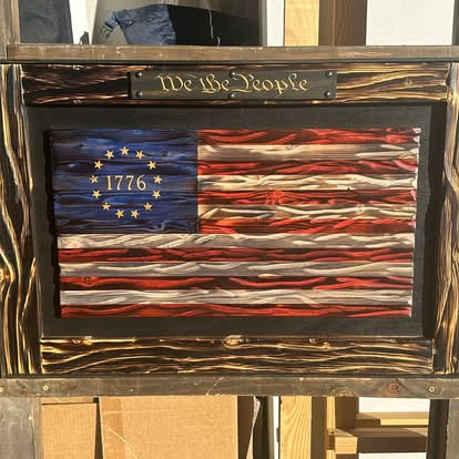 We the People 1776 flag in a burned wood frame